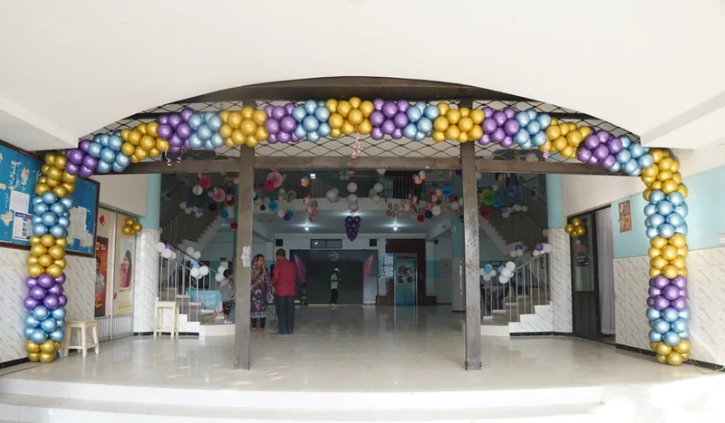 Colourful balloon arch framing a venue entrance