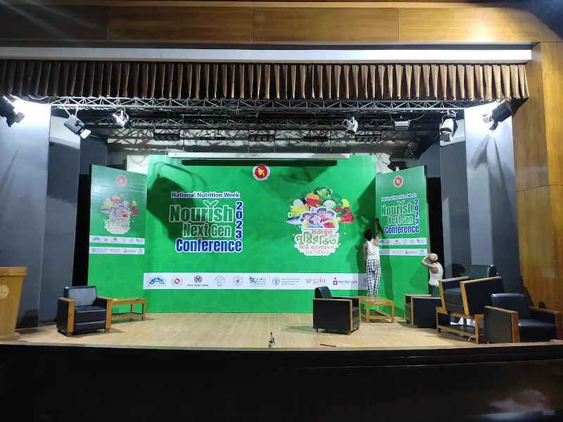 Printed conference stage backdrop with lighting and podium setup