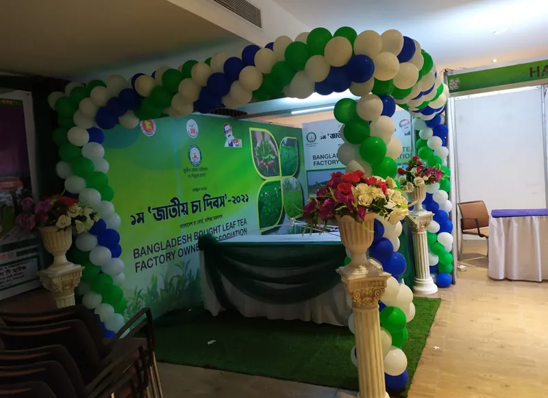 Green and white balloon arch with branded entrance panel