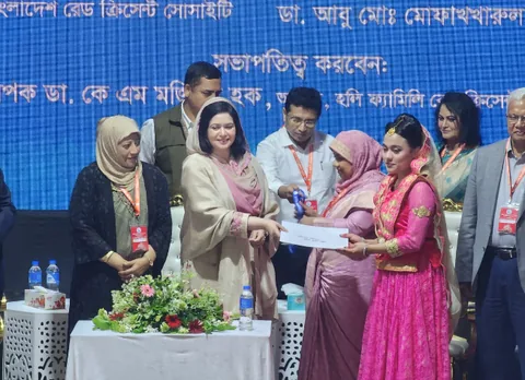 Certificate handover ceremony in front of a printed event backdrop