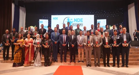 Corporate group photograph on the branded NDE event stage